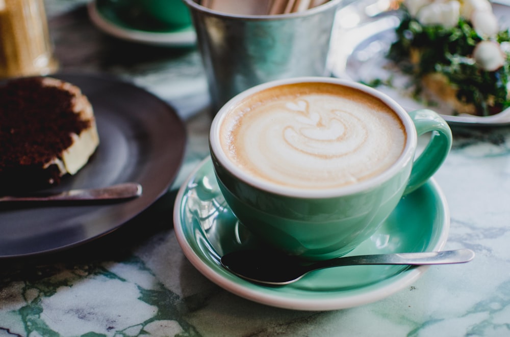 teal teacup and saucer on table