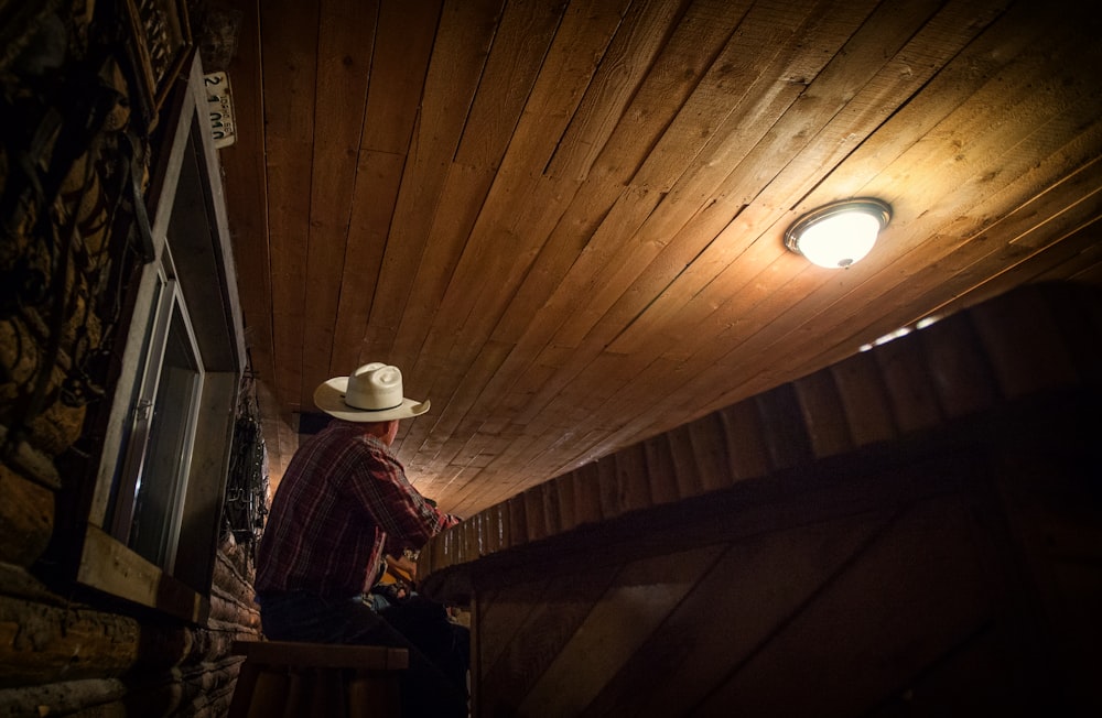 man sitting on chair while looking up