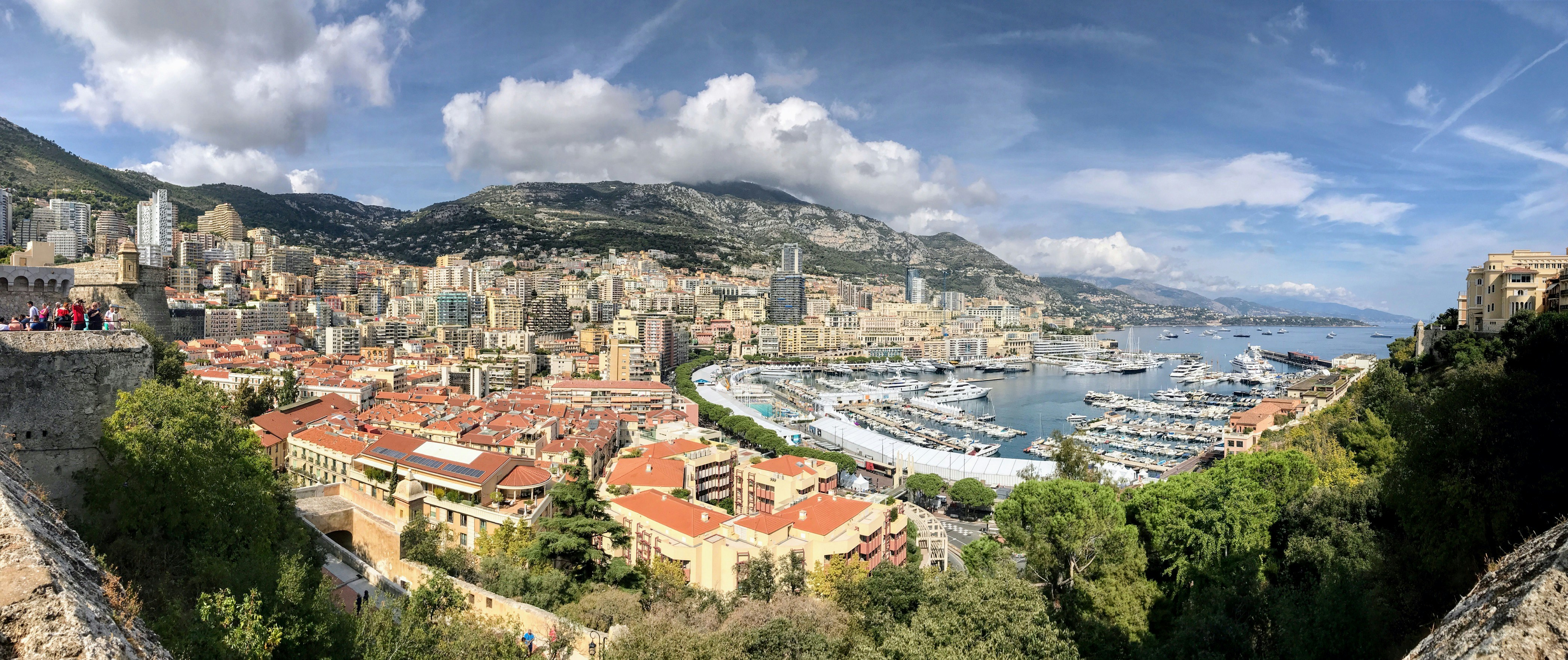 Aerial view of Monaco coastline, bright daylight, turquoise Mediterranean, yachts in harbour