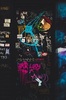 a door covered in graffiti and stickers