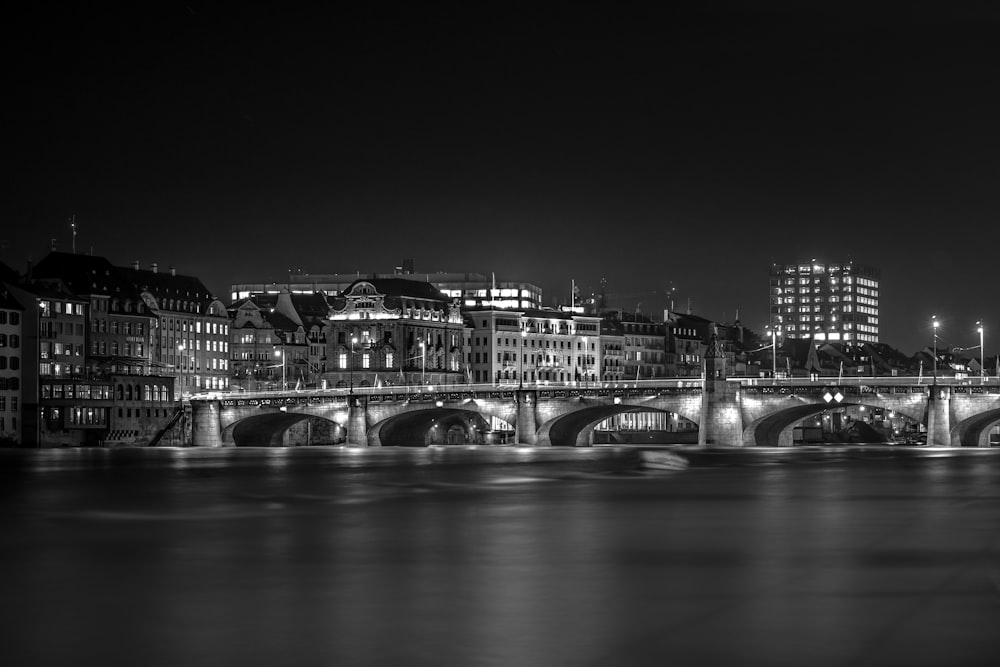 grayscale photography of bridge and city buildings