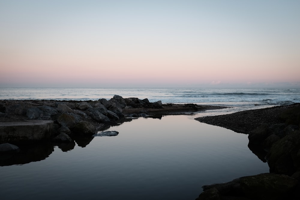 body of water during sunset