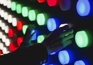 people holding assorted-color LED lights