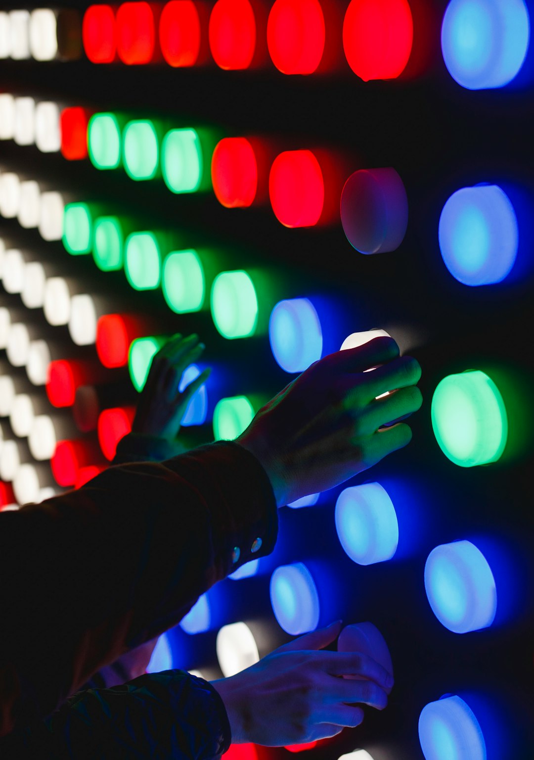  people holding assorted color led lights button