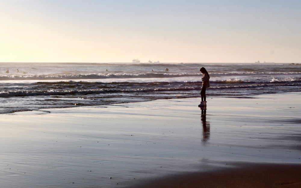 woman standing near body of water