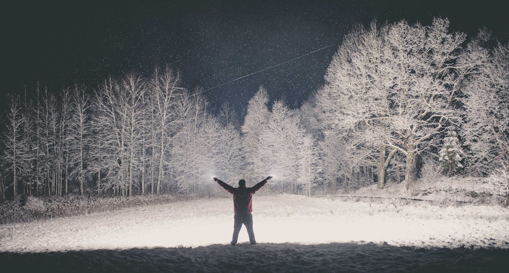 man standing near trees during nighttime