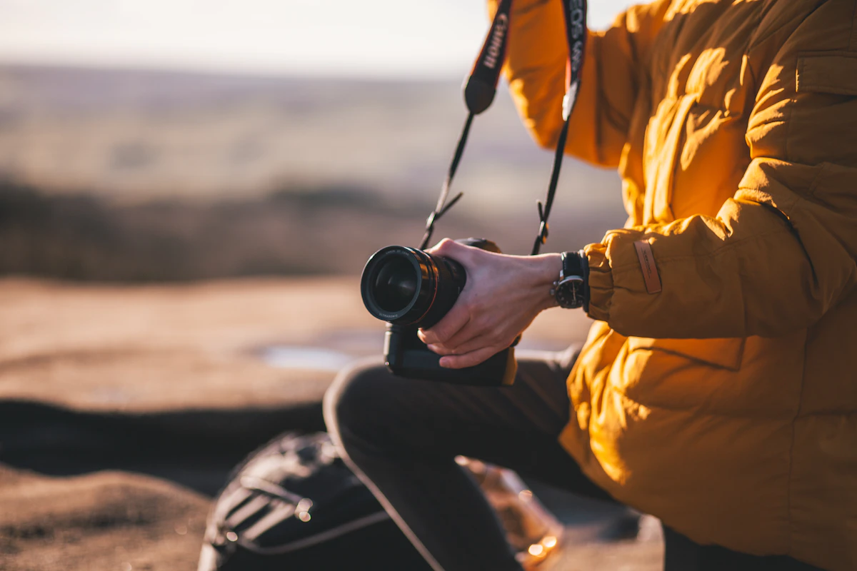 Photographer holding Canon camera during a travel shooting moment