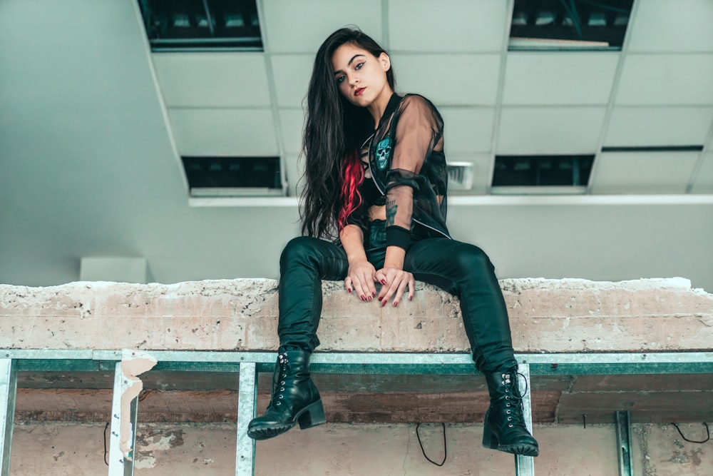 woman sitting on concrete block