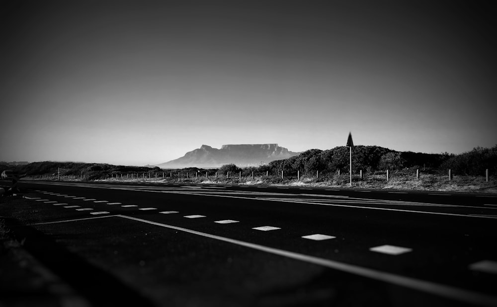 empty road in grayscale photography