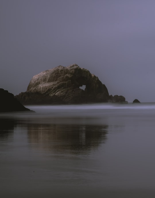 rock formation under gray sky in Sutro Baths United States