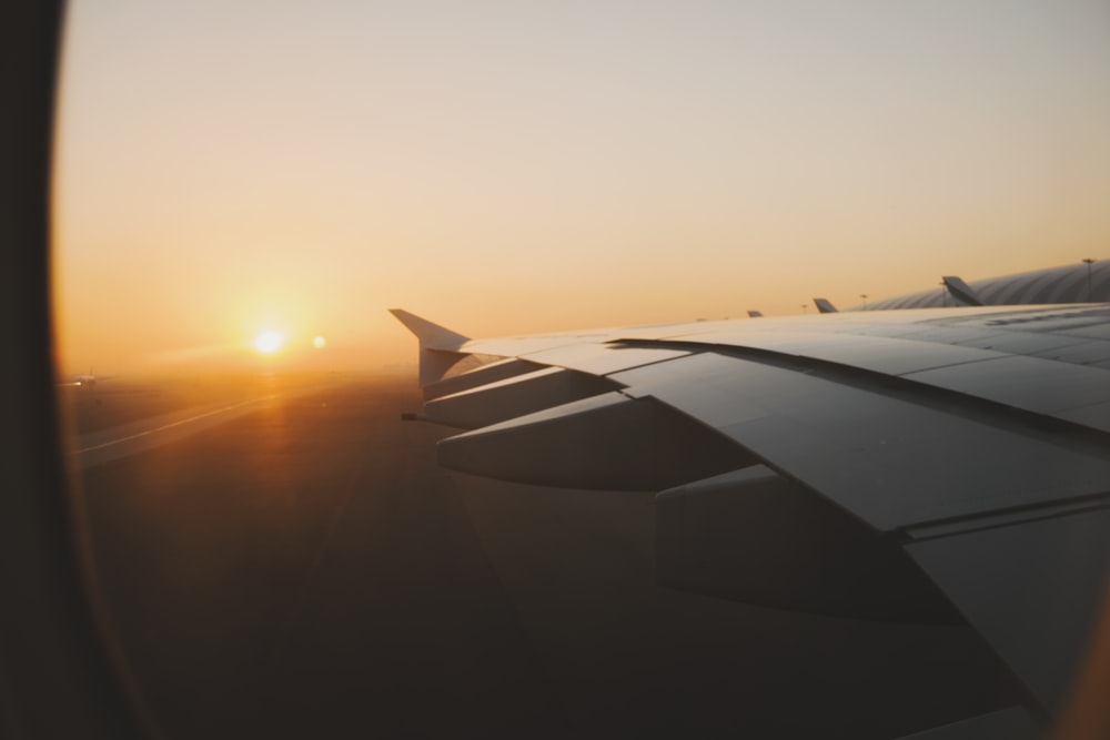 left side wing of airplane during golden hour