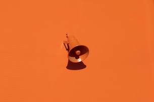 orange megaphone on orange wall