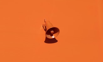 orange megaphone on orange wall