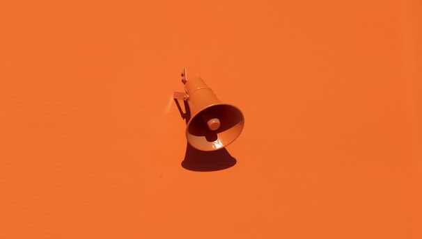 orange megaphone on orange wall