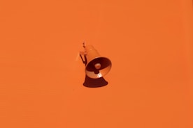 orange megaphone on orange wall