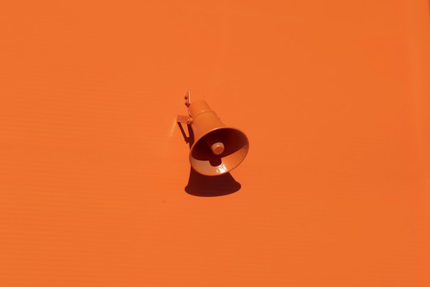 orange megaphone on orange wall