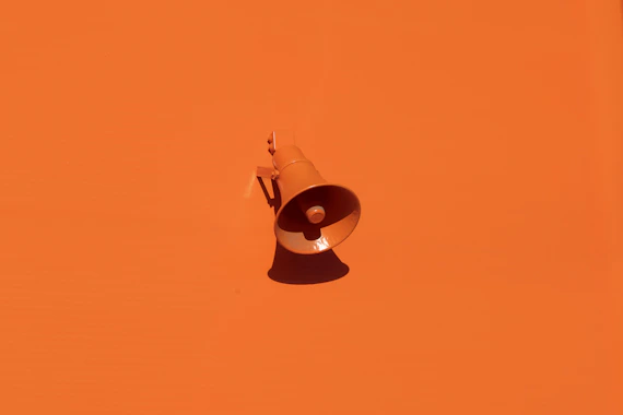 orange megaphone on orange wall