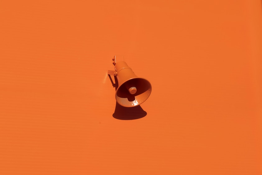 orange megaphone on orange wall