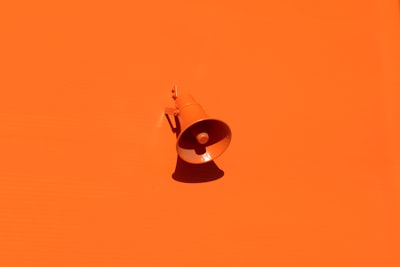 orange megaphone on orange wall bold teams background