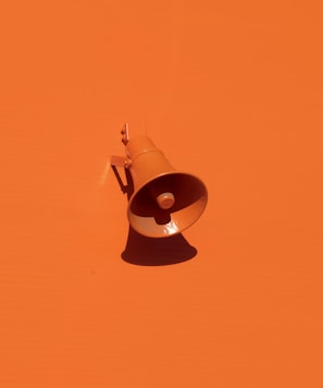 orange megaphone on orange wall