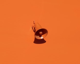 orange megaphone on orange wall