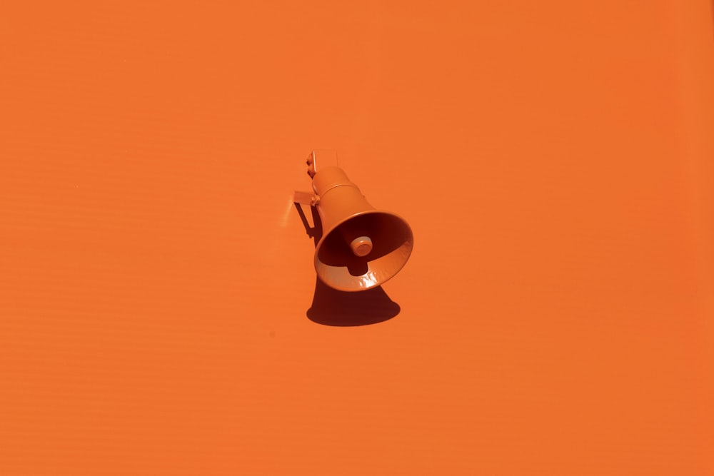 orange megaphone on orange wall