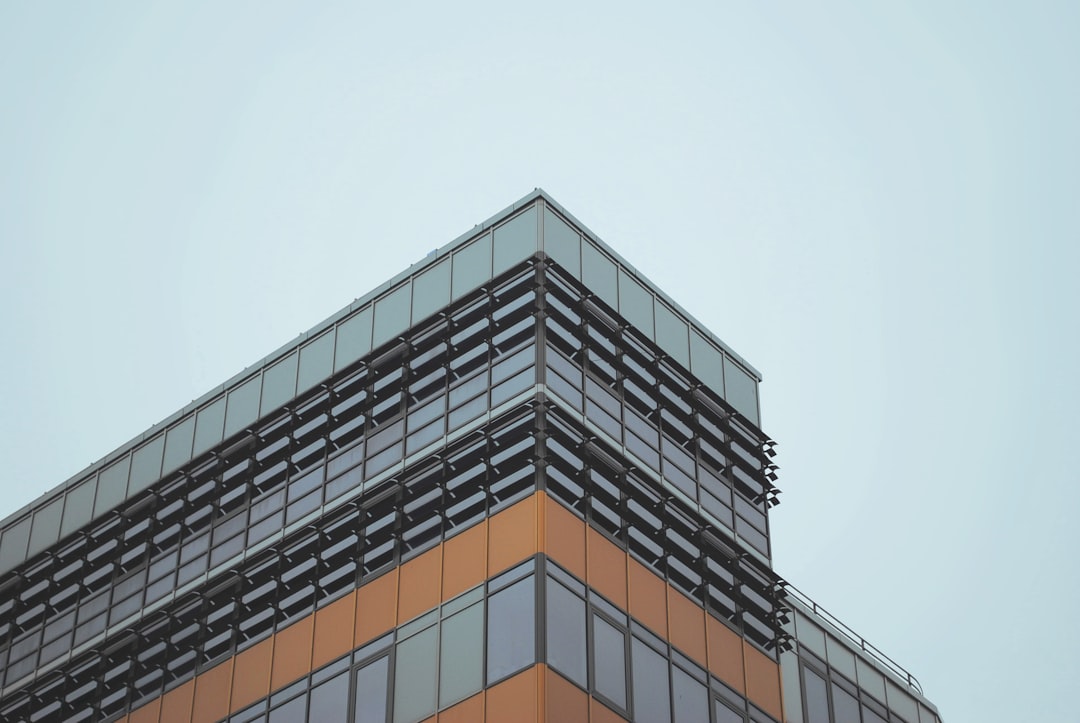 low-angled photography of concrete building under cloudy sky