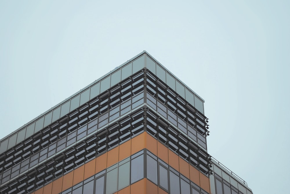 low-angled photography of concrete building under cloudy sky