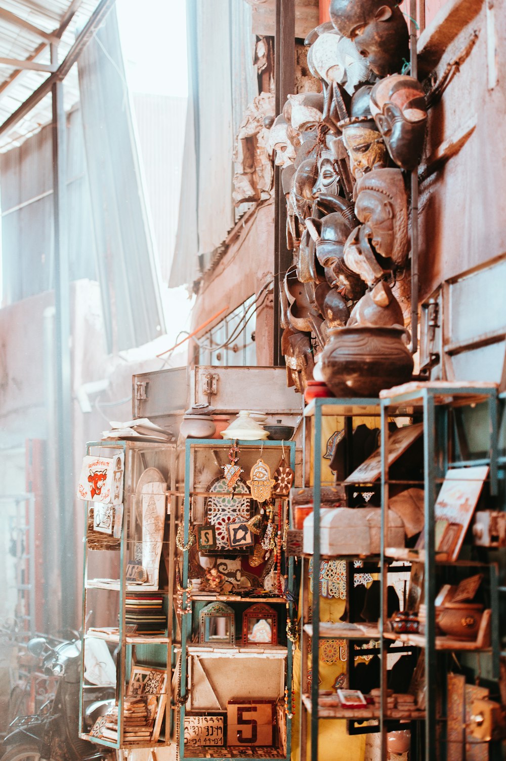 shelf of decorative masks and home ornaments