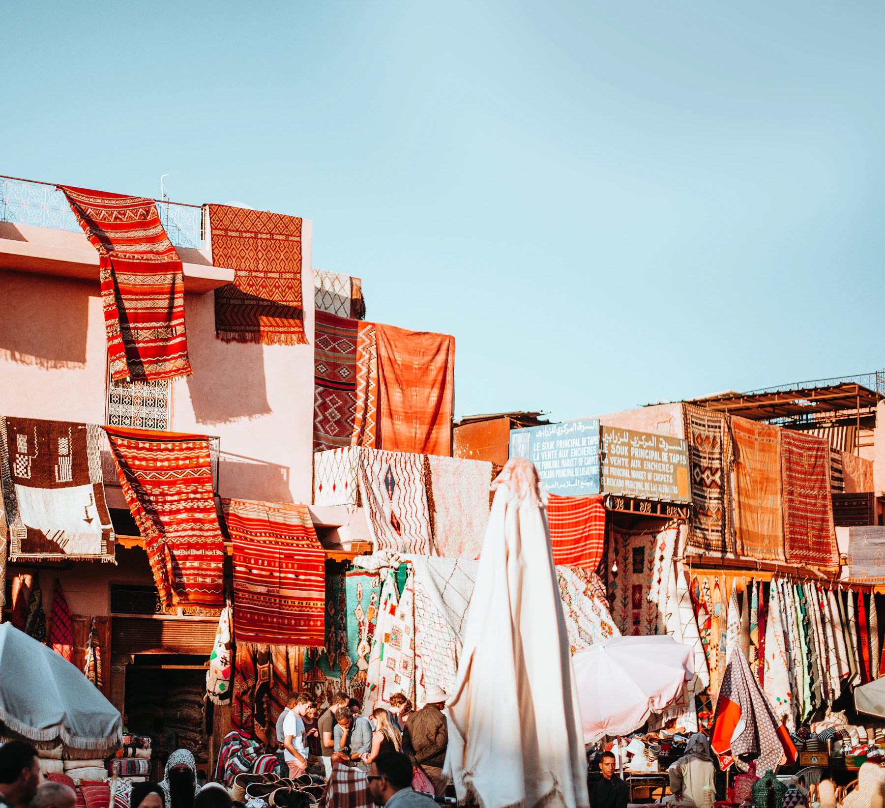 Colorful handwoven textiles in a Marrakech souk