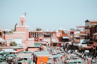 Wide shot of a busy street in Ouarzazate featuring multiple Sud Media advertising installations.