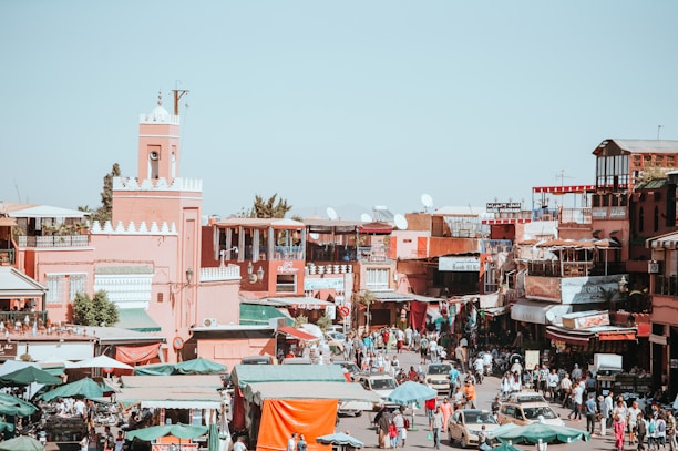 A vibrant Moroccan cityscape showing diverse local businesses and bustling streets.