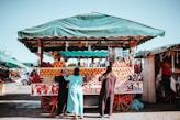 three women in front of fruit carriage stand