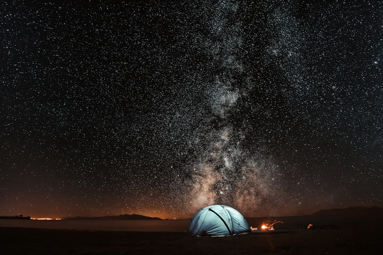blue tent under milkyway powered with solar panels