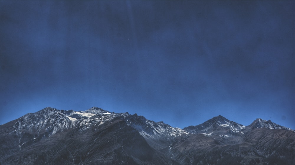 mountain range under blue sky