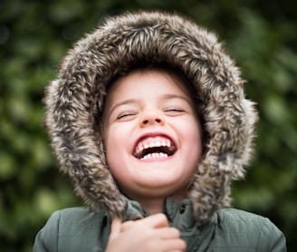 selective focus photography of child laughing