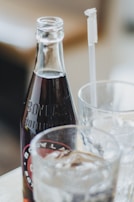 Chilled craft soda and a casual wooden table setting that invites to a relaxed snack moment.