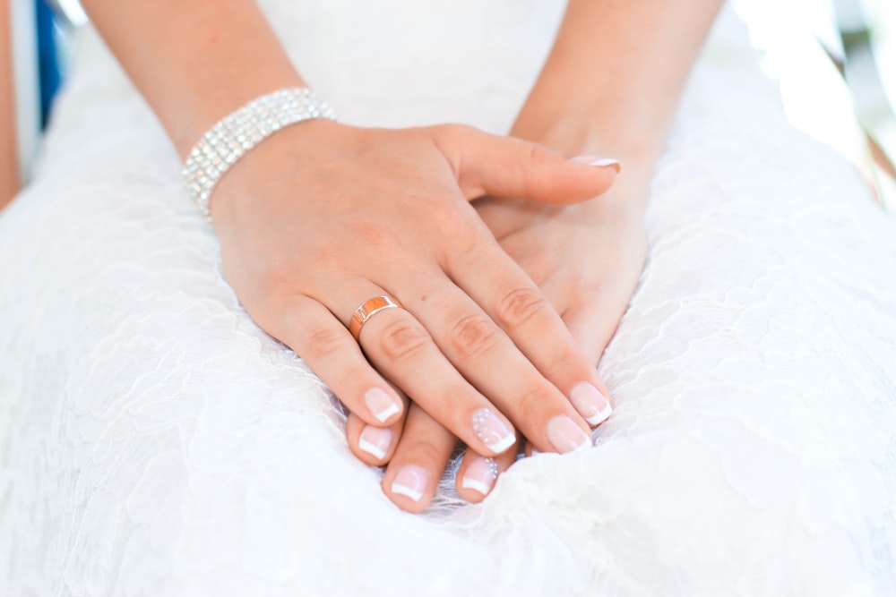 a close up of a person wearing a wedding ring