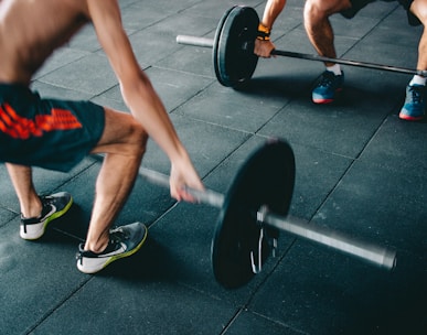 a man lifting a barbell in a gym