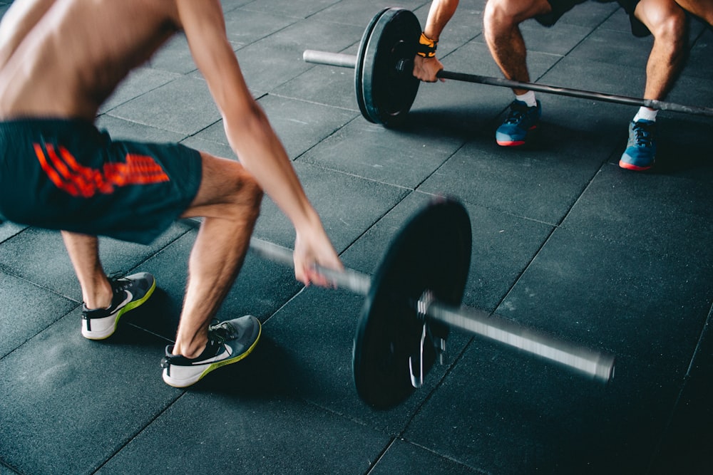 a man lifting a barbell in a gym