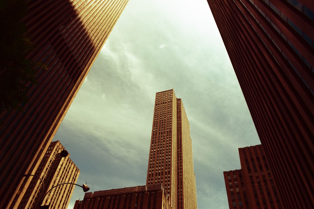 brown concrete building under white clouds during daytime