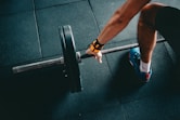 man holding black barbell