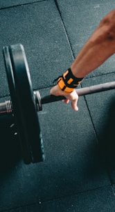 man holding black barbell