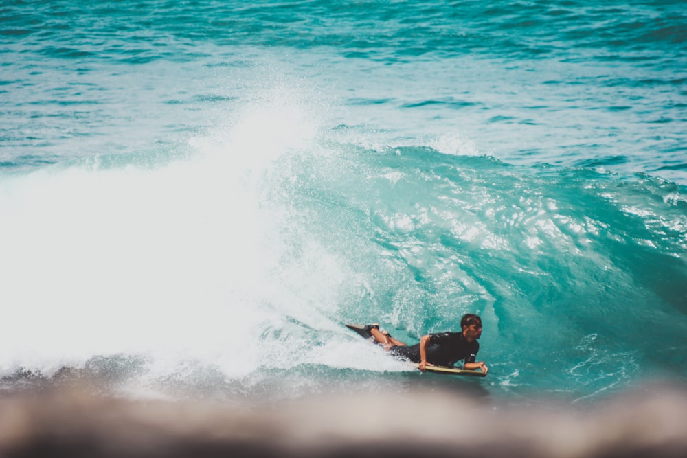 man surfing on sea waves