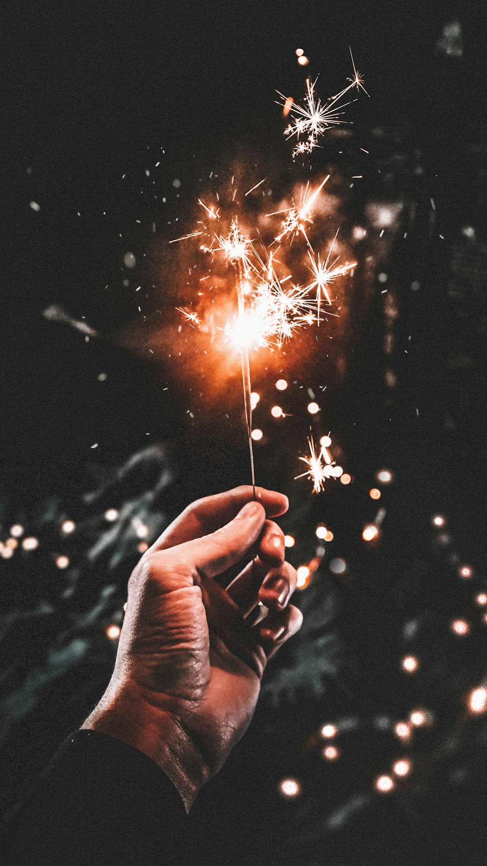 time-lapse photography of person holding firecracker