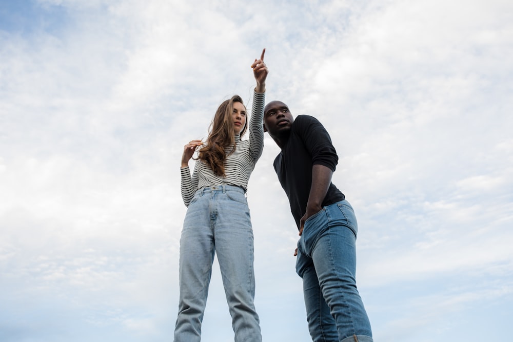 photography of woman pointing her finger near an man