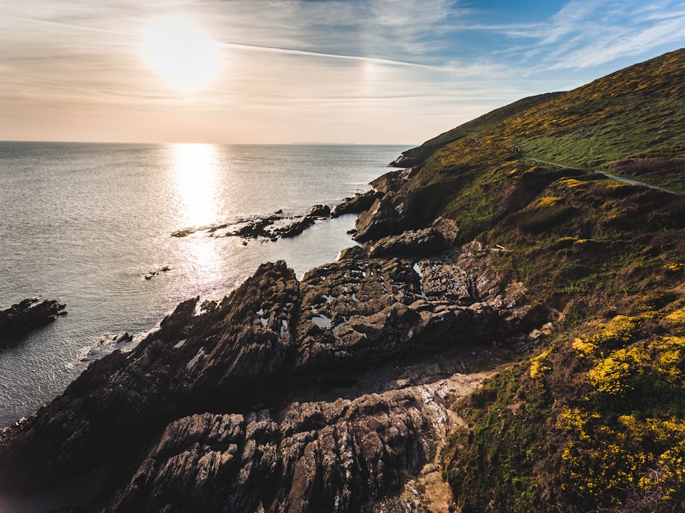 rock formation near ocean water during daytime