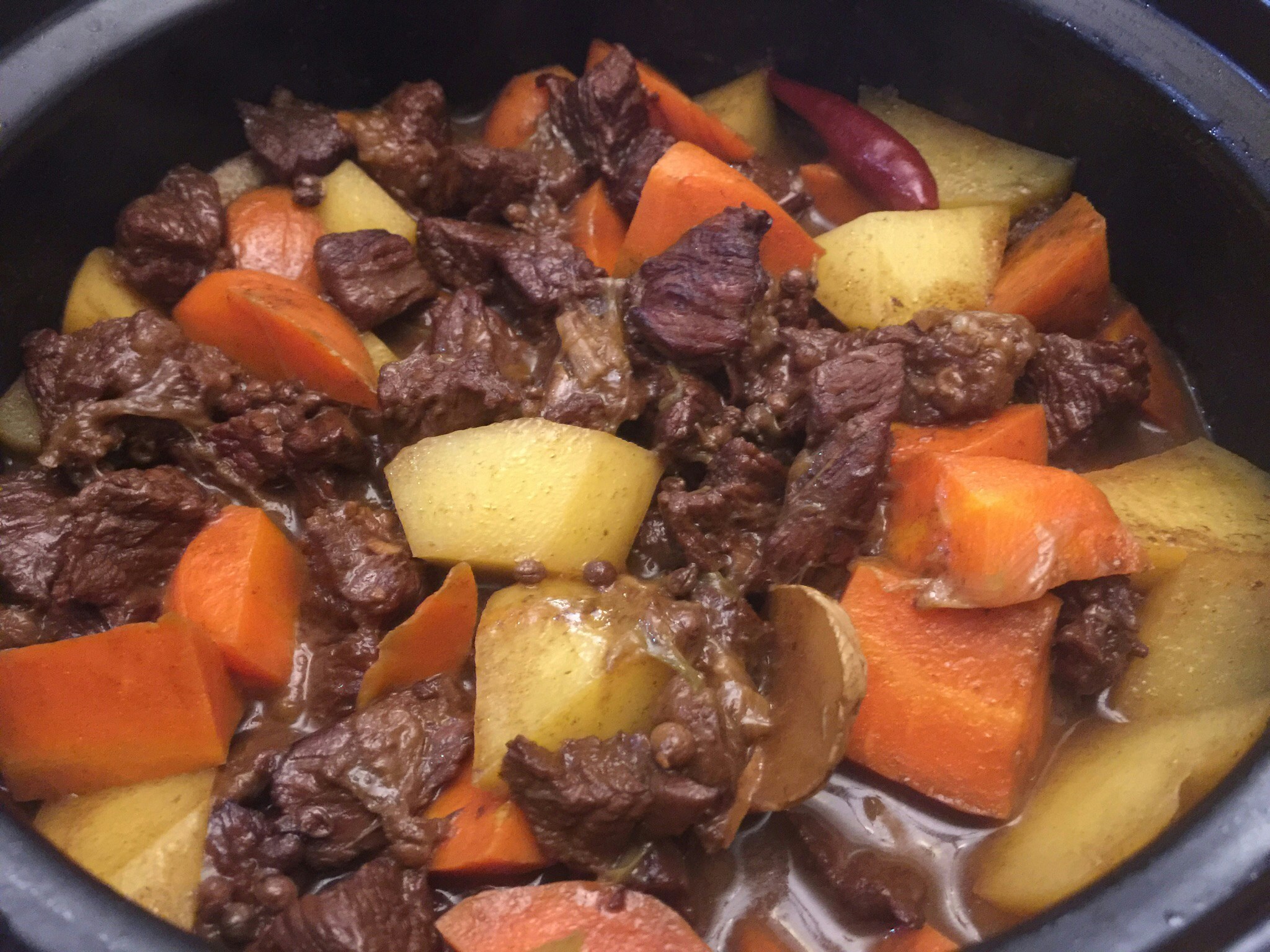 Rich beef stew with vegetables in dark sauce