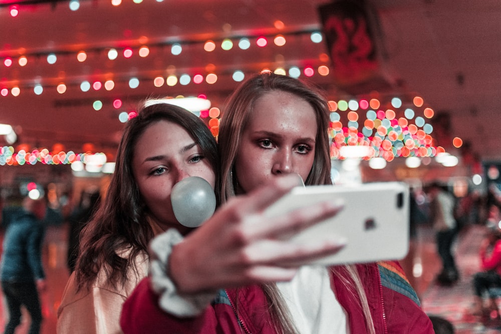 women takes photo inside building near people