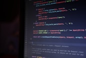 A computer screen is displaying lines of colorful code. The syntax is highlighted in different colors, with keywords in red, operators in blue, and strings in green. The code appears to involve data query and replacement functions.